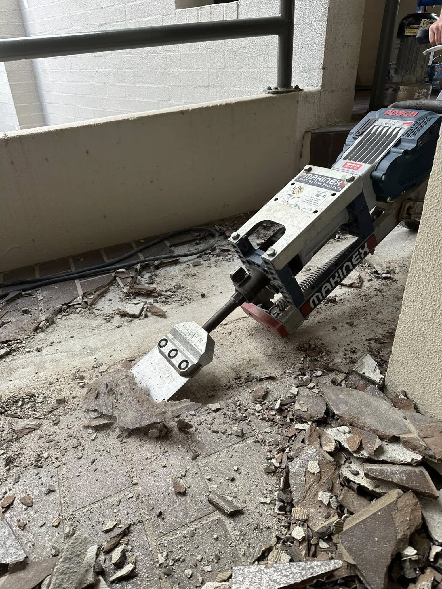 Tile removal and floor preparation machine removing old tiles